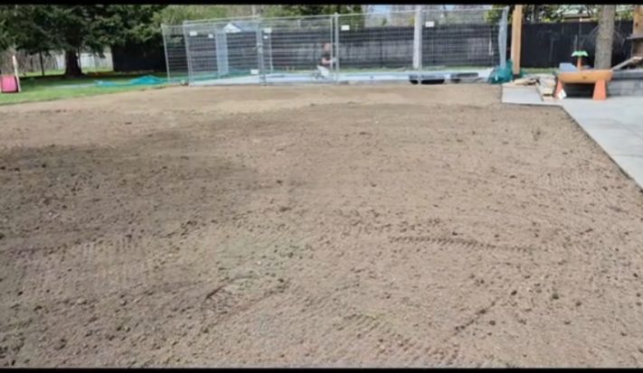 Cour arrière en terre nivelée et compactée, prête à recevoir la tourbe, près d’une piscine
